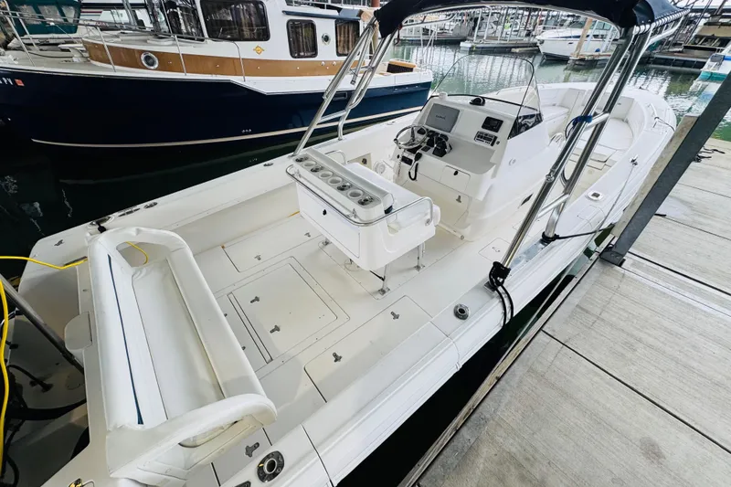 Slide: The Image of 2008 Intrepid 327 boat docked, featuring spacious deck and modern controls. - 3