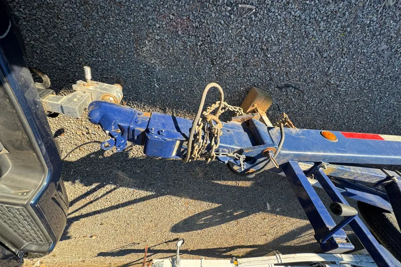 Slide: The Image of Trailer hitch of a 2008 Intrepid 327, secured with chains on gravel surface. - 31