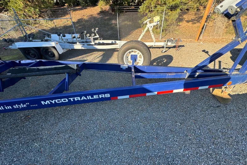 Slide: The Image of Blue Myco trailer for 2008 Intrepid 327 boat on gravel lot. - 33