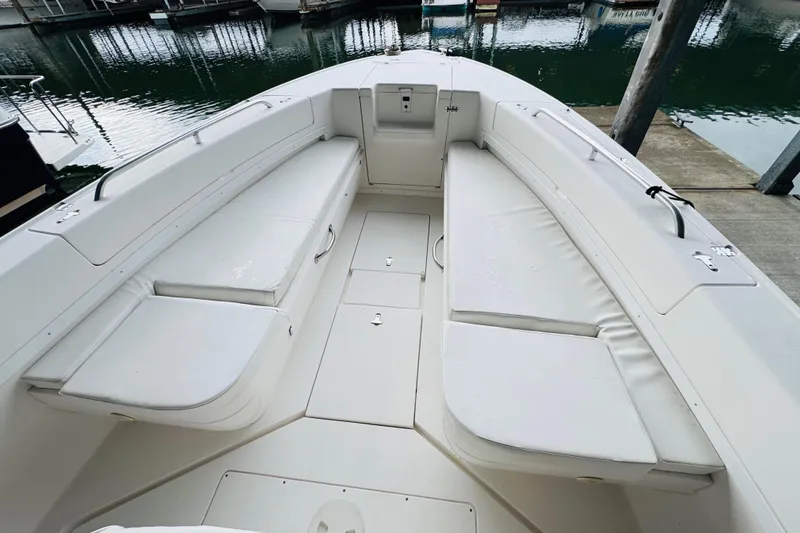 Slide: The Image of 2008 Intrepid 327 boat interior with cushioned seating, docked at marina. - 4