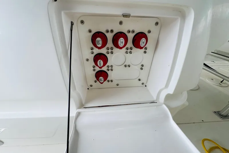 Slide: The Image of Electrical panel on a 2008 Intrepid 327 boat, featuring red switches and white casing. - 7