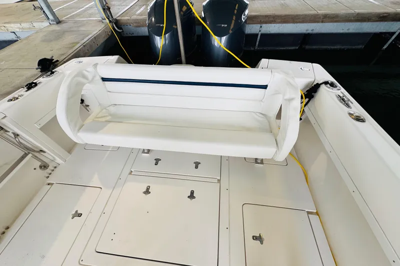 Slide: The Image of 2008 Intrepid 327 boat interior with white seating and storage compartments. - 9