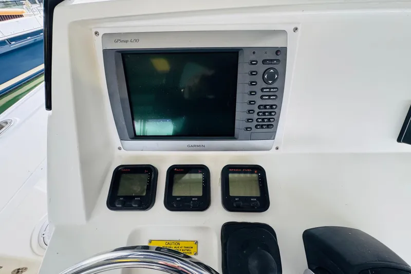 Slide: The Image of 2008 Intrepid 327 boat dashboard with Garmin GPSmap 4210 and digital displays. - 11