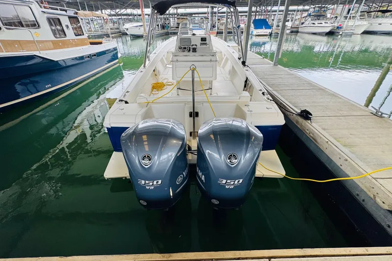 Slide: The Image of 2008 Intrepid 327 boat with twin Yamaha 350 V8 engines docked in marina. - 2