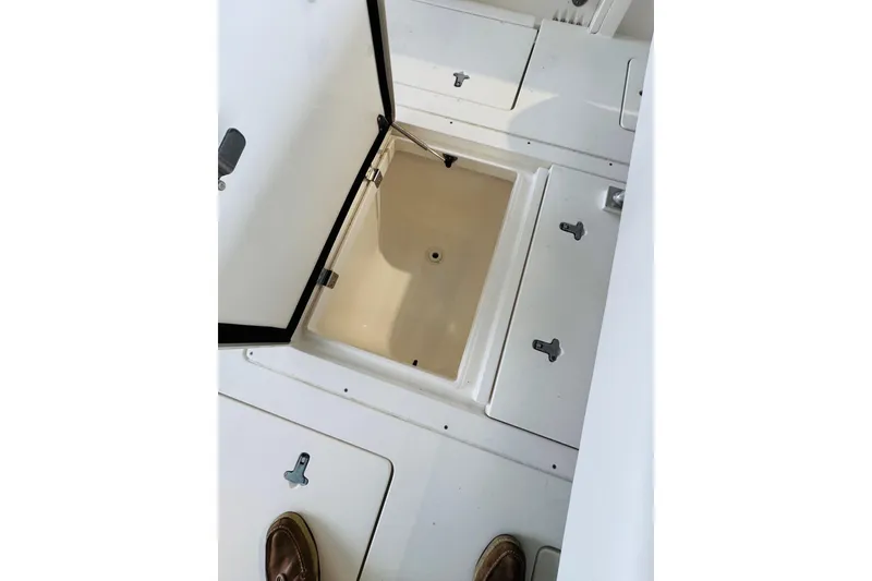 Slide: The Image of Open storage compartment on 2008 Intrepid 327 boat deck. - 23