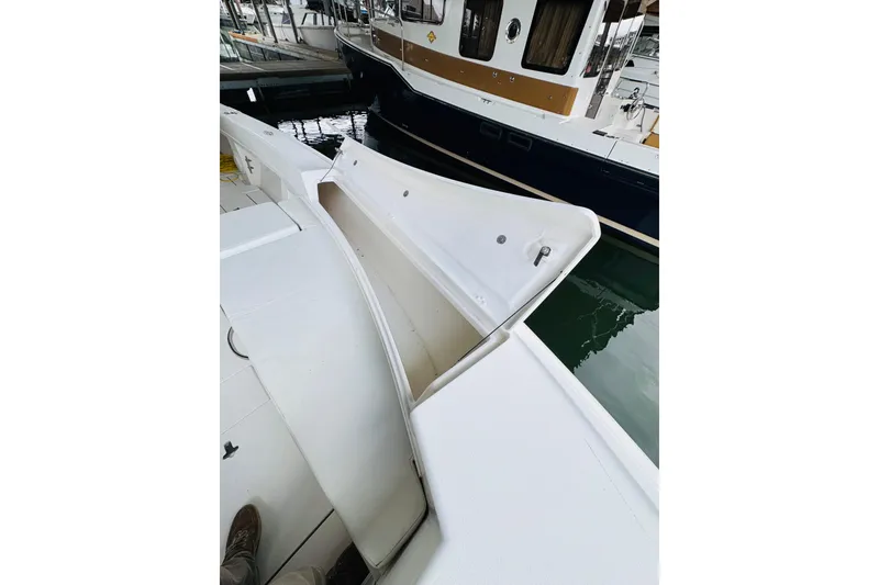 Slide: The Image of 2008 Intrepid 327 boat with open storage compartment at marina. - 24