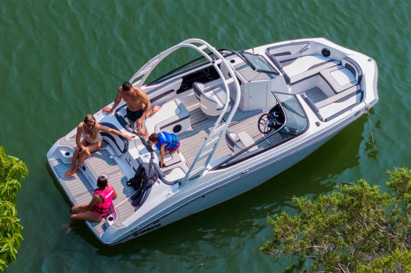 Slide: The Image of 2026 Yamaha Boats 195S on water with passengers enjoying a sunny day. - 14