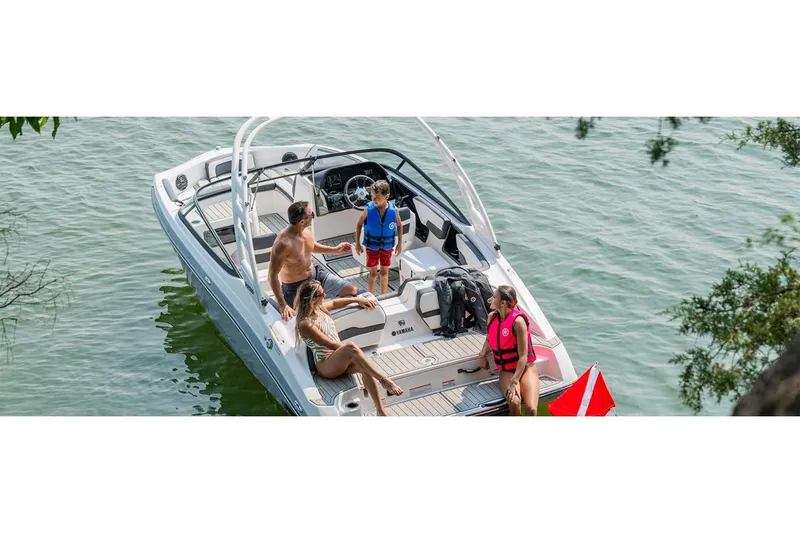 Slide: The Image of 2026 Yamaha Boats 195S with people enjoying a sunny day on the water. - 2