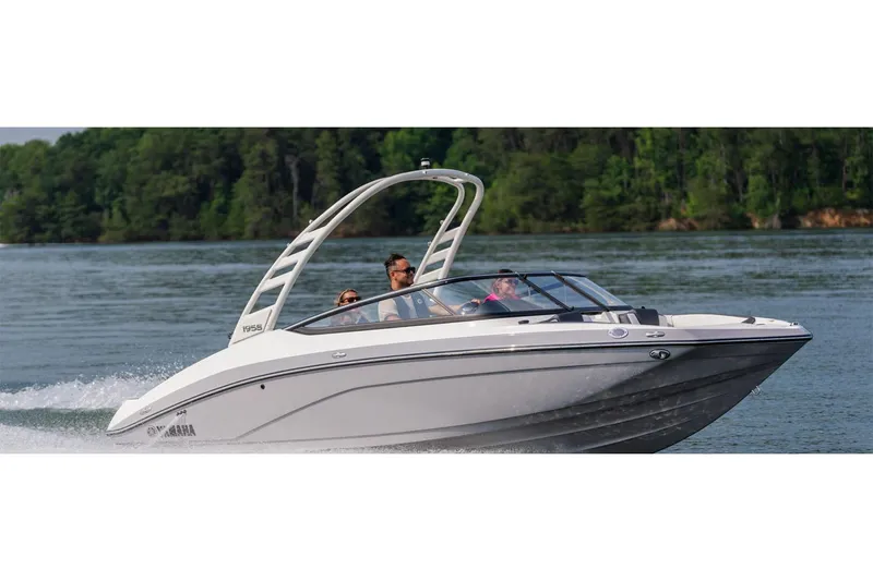 Slide: The Image of 2026 Yamaha Boats 195S cruising on a lake with lush green trees in the background. - 9