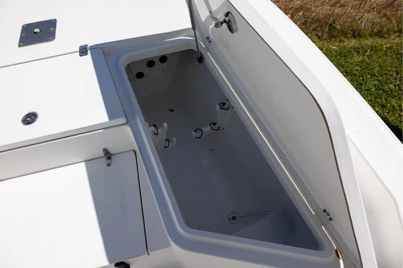 Slide: The Image of Open storage compartment on a 2016 Sea Hunt BX 24 BR boat. - 14