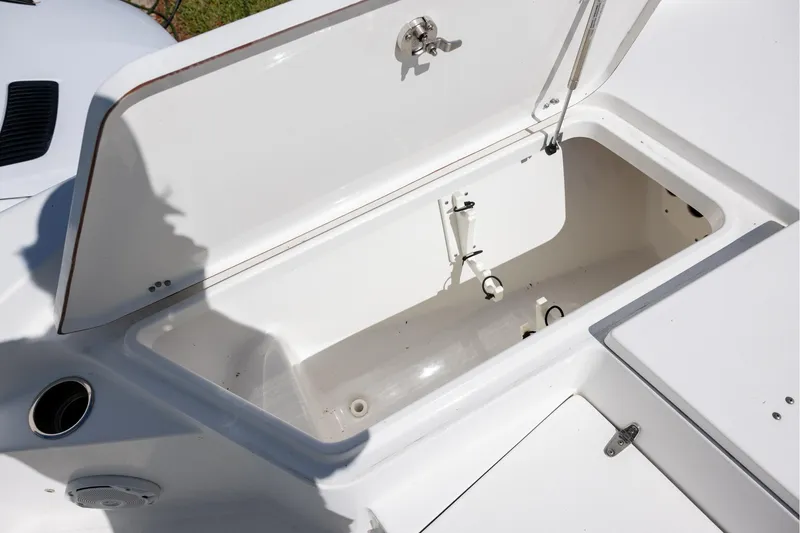 Slide: The Image of Open storage compartment on a 2016 Sea Hunt BX 24 BR boat. - 15