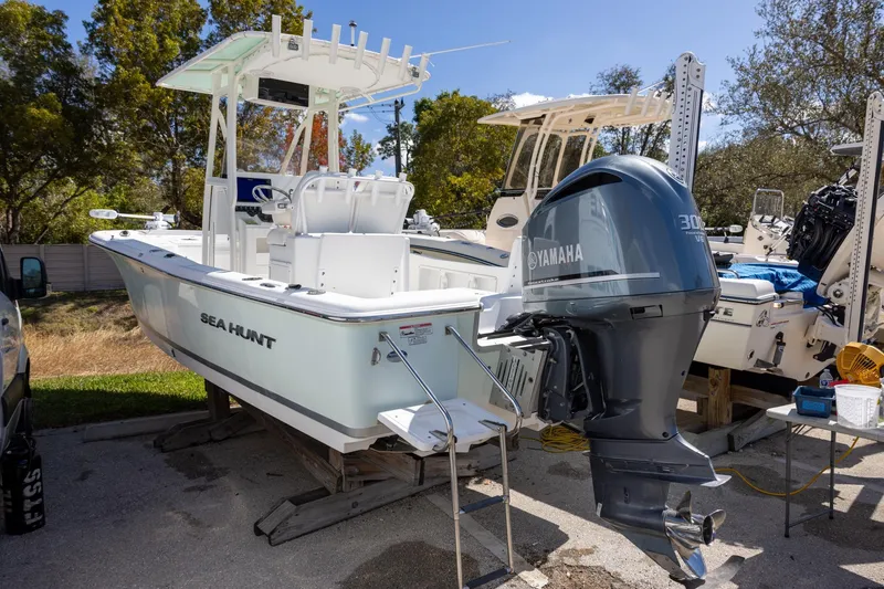 Slide: The Image of 2016 Sea Hunt BX 24 BR boat with Yamaha engine, parked outdoors. - 2