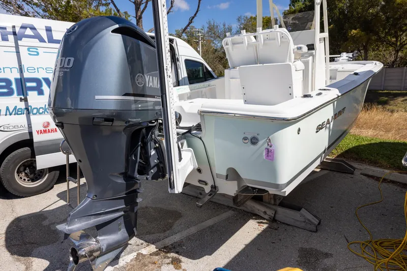 Slide: The Image of 2016 Sea Hunt BX 24 BR boat with Yamaha outboard motor in a parking area. - 3