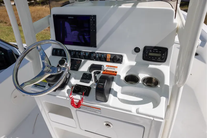 Slide: The Image of 2016 Sea Hunt BX 24 BR boat console with steering wheel and navigation controls. - 6
