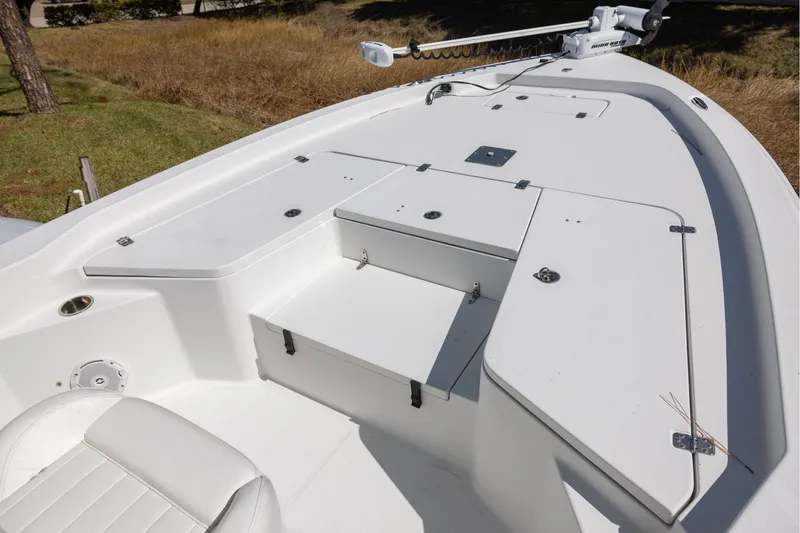 Slide: The Image of 2016 Sea Hunt BX 24 BR boat deck with storage compartments and seating. - 9
