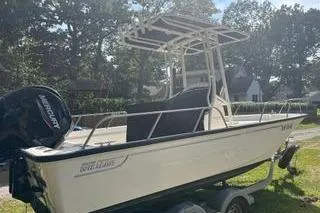 Slide: The Image of 2022 Boston Whaler 190 Montauk boat on trailer, parked outdoors. - 2