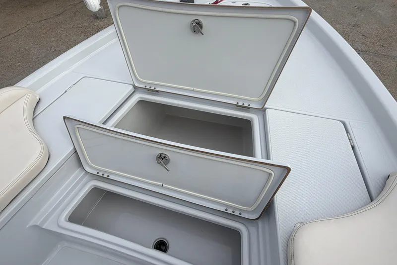 Slide: The Image of 2021 Blue Wave 2400 PureBay boat storage compartments open, showcasing interior space. - 11