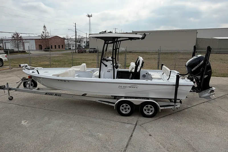 Slide: The Image of 2021 Blue Wave 2400 PureBay boat on trailer, parked outdoors. - 5
