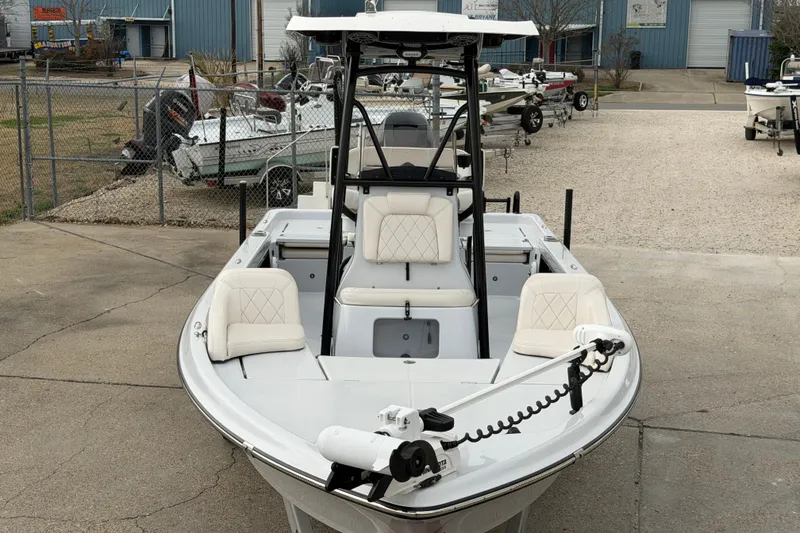 Slide: The Image of 2021 Blue Wave 2400 PureBay boat with white seating, parked in a marina. - 7