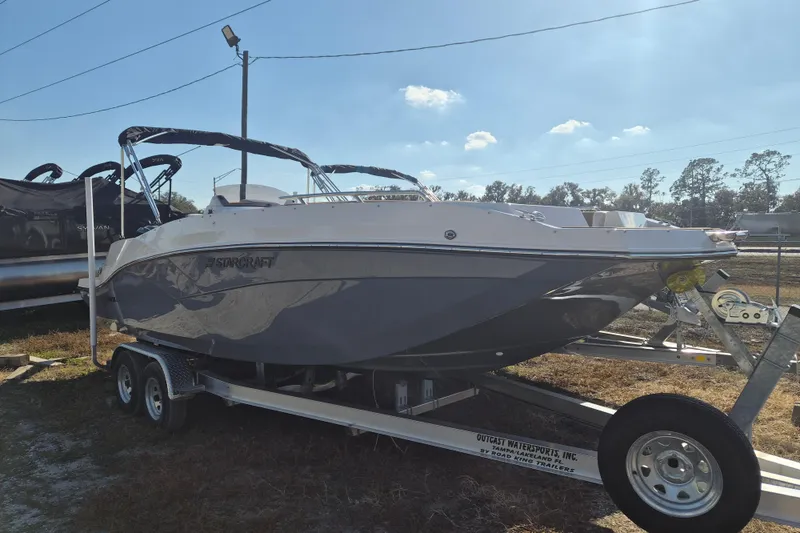 Slide: The Image of 2026 Starcraft SVX 231 OB DH boat on trailer with Yamaha outboard motor. - 1