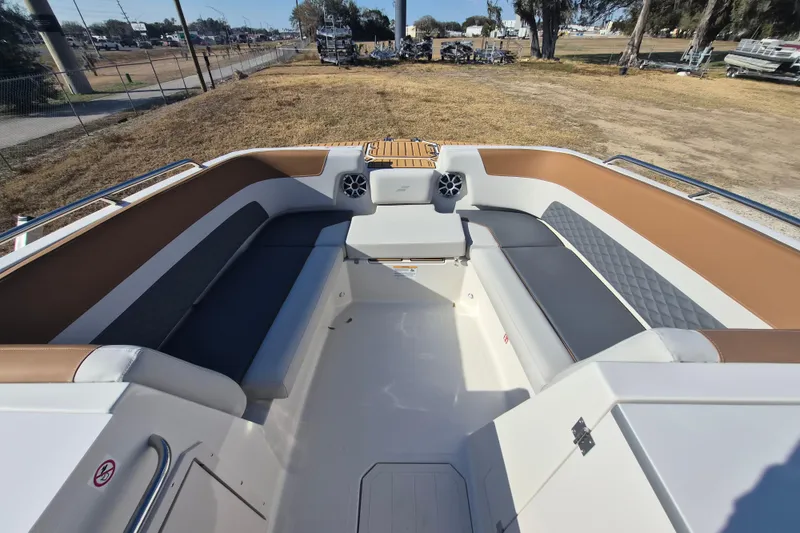 Slide: The Image of 2026 Starcraft SVX 231 OB DH boat interior with tan and gray seating, wood-style flooring. - 11