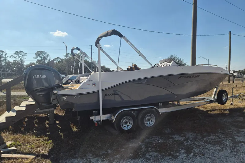 Slide: The Image of 2026 Starcraft SVX 231 OB DH boat with Yamaha 250 V6 engine displayed outdoors. - 2