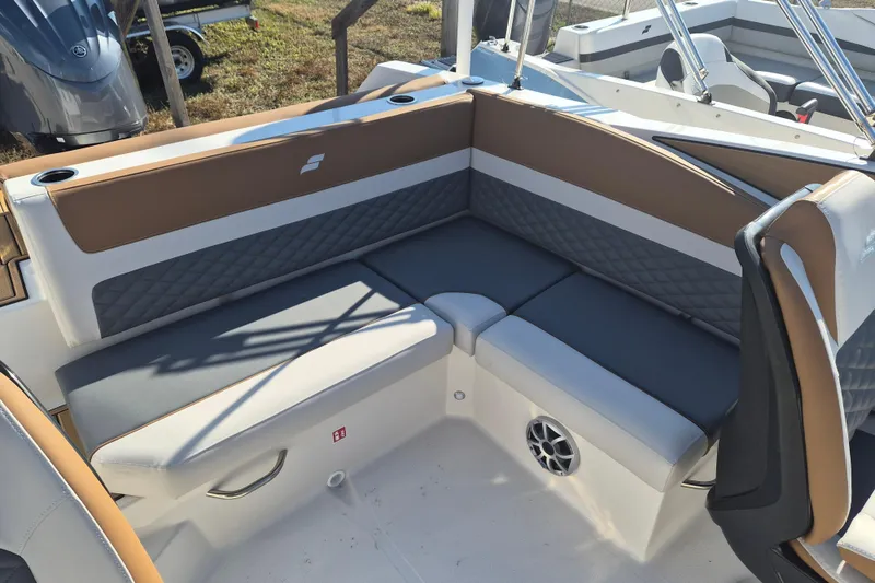 Slide: The Image of 2026 Starcraft SVX 231 OB DH boat cockpit with steering wheel and captain's chair. - 7