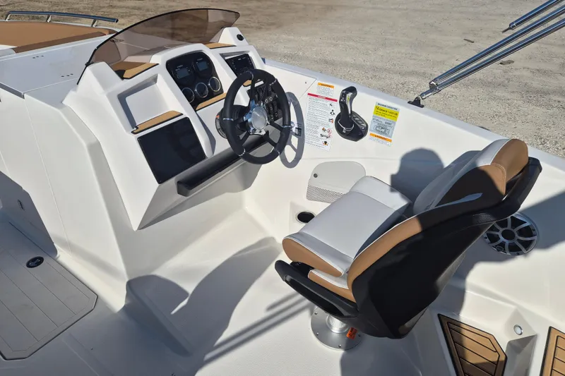 Slide: The Image of 2026 Starcraft SVX 231 OB DH boat dashboard with steering wheel and control panel. - 8