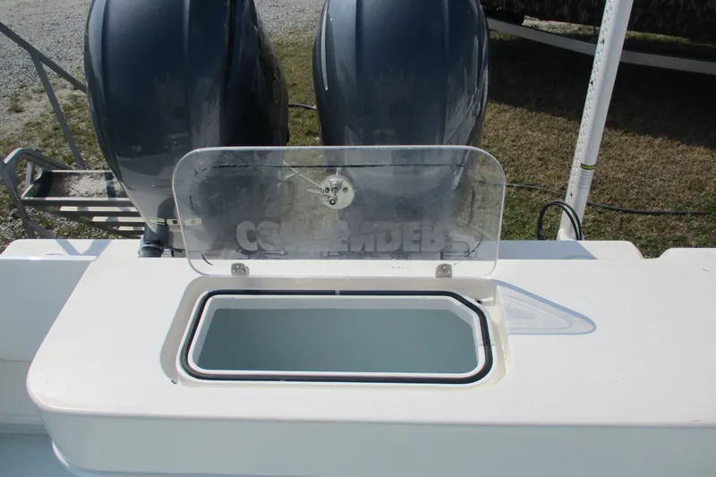 Slide: The Image of 2019 Contender 25 Tournament boat with open storage compartment and dual engines. - 19
