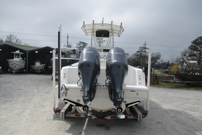 Slide: The Image of 2019 Contender 25 Tournament boat with dual Yamaha 200 engines, parked outdoors. - 4