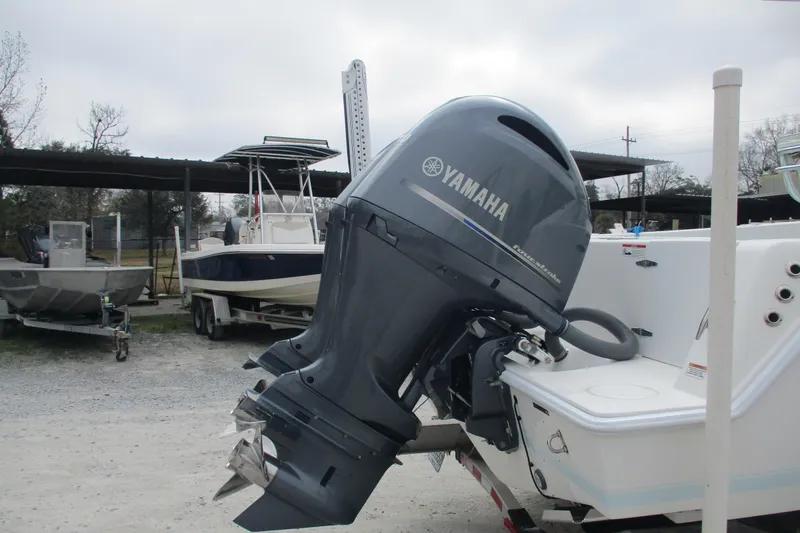 Slide: The Image of 2019 Contender 25 Tournament boat with Yamaha outboard motor in a marina setting. - 5
