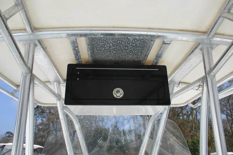 Slide: The Image of 2019 Contender 25 Tournament boat console with storage compartment, featuring sturdy metal framework. - 7