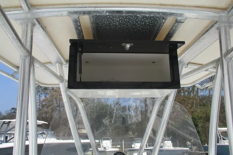 Slide: The Image of 2019 Contender 25 Tournament boat console with open storage compartment. - 8