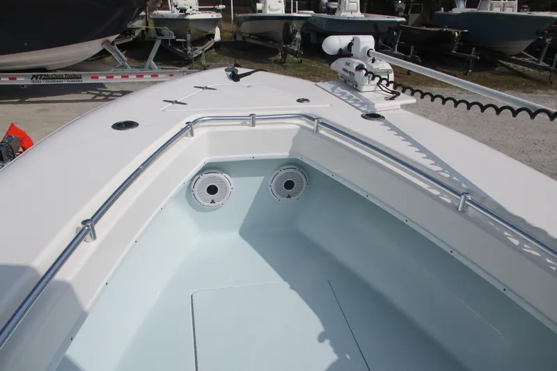 Slide: The Image of 2019 Contender 25 Tournament boat bow with speakers and railing, parked on a trailer. - 9