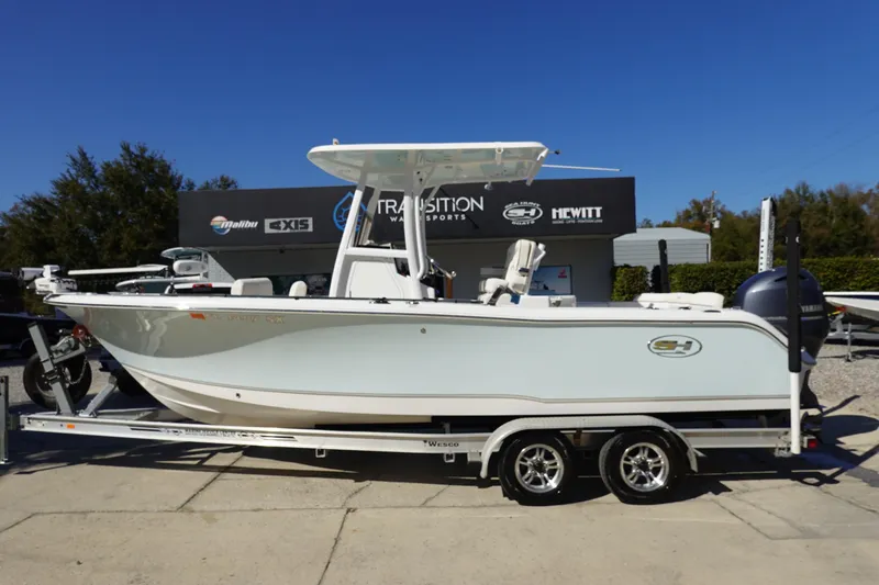 The Image of 2021 Sea Hunt Ultra 234 boat on trailer, displayed outdoors at dealership. - 1