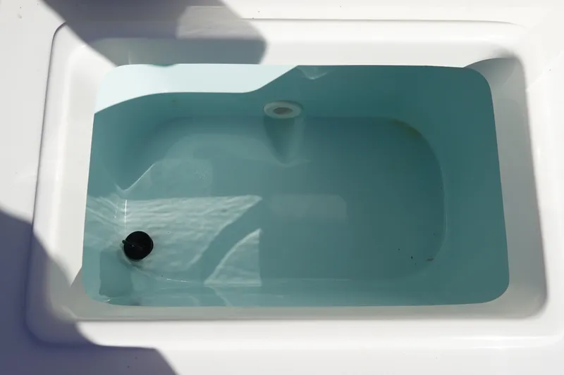 Slide: The Image of Livewell in 2021 Sea Hunt Ultra 234 boat, filled with water. - 12