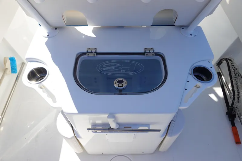 Slide: The Image of 2021 Sea Hunt Ultra 234 boat console with storage and cup holders. - 15