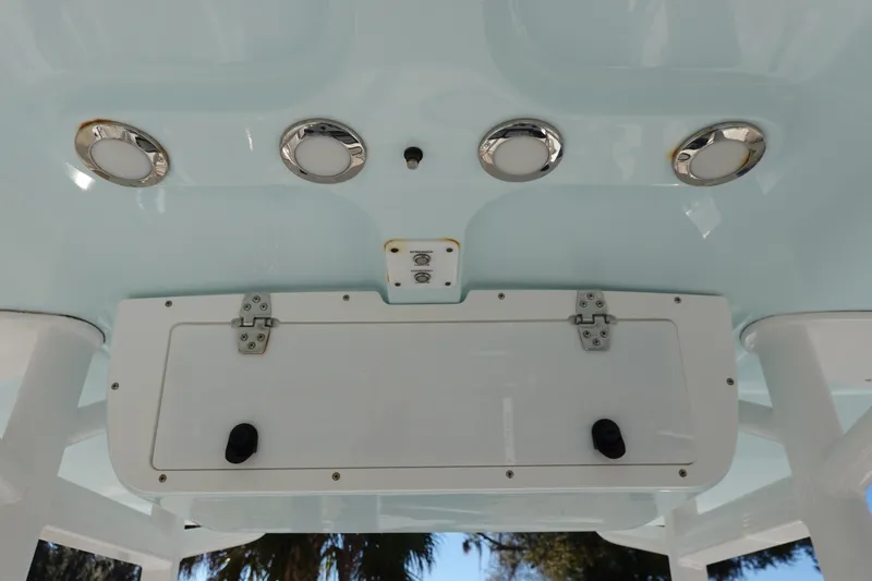 Slide: The Image of 2021 Sea Hunt Ultra 234 boat ceiling with lights and storage compartment. - 22