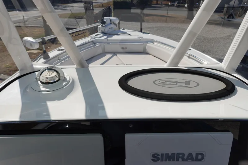 Slide: The Image of 2021 Sea Hunt Ultra 234 boat dashboard with compass and Simrad display. - 24