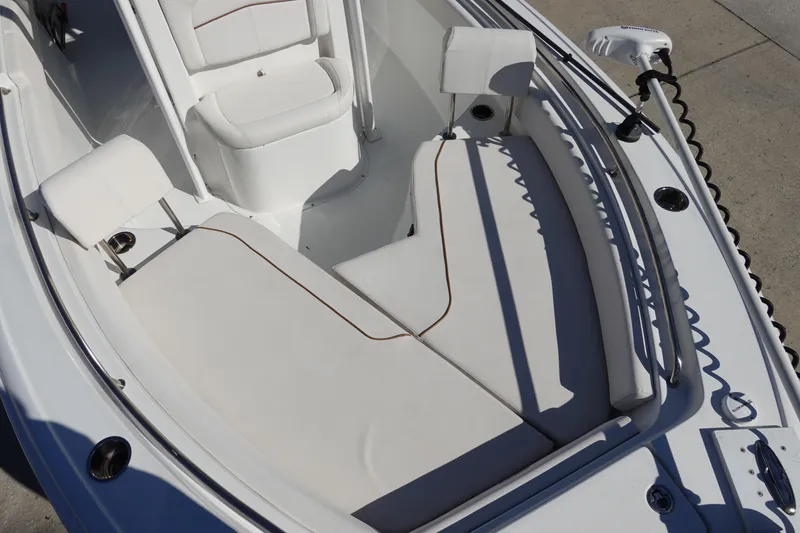 Slide: The Image of 2021 Sea Hunt Ultra 234 boat interior with white cushioned seating. - 28