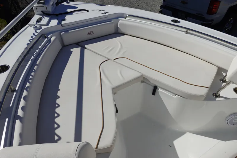 Slide: The Image of 2021 Sea Hunt Ultra 234 boat with white cushioned seating area. - 29