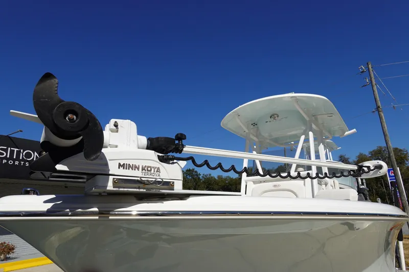 Slide: The Image of 2021 Sea Hunt Ultra 234 boat with Minn Kota Terrova trolling motor under clear blue sky. - 3