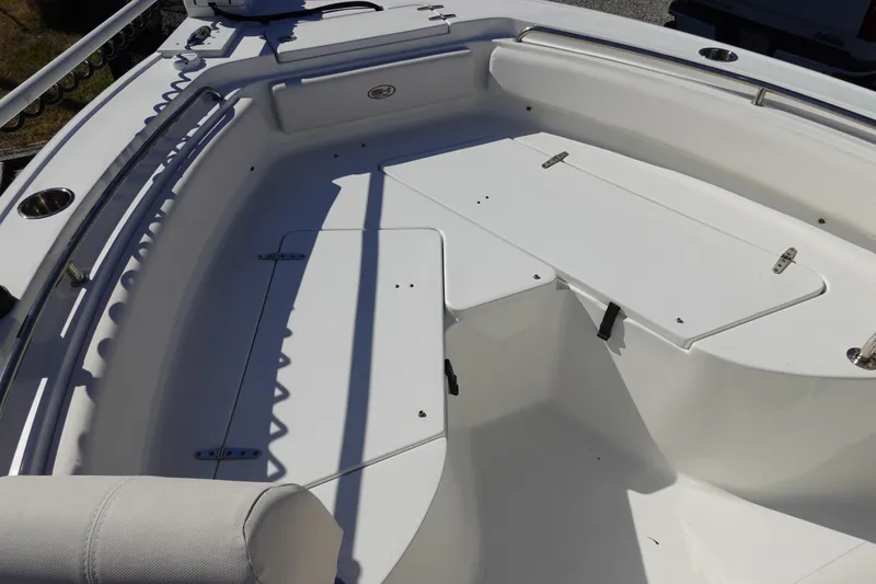 Slide: The Image of 2021 Sea Hunt Ultra 234 boat interior with seating and storage compartments. - 30