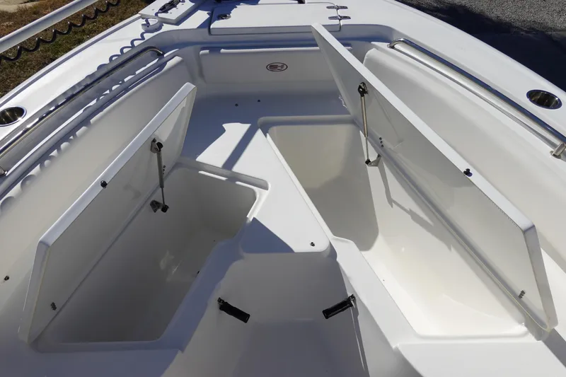 Slide: The Image of 2021 Sea Hunt Ultra 234 boat storage compartments open, showcasing spacious interior design. - 31