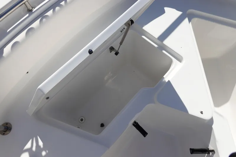 Slide: The Image of Open storage compartment on 2021 Sea Hunt Ultra 234 boat, featuring sleek white design. - 32