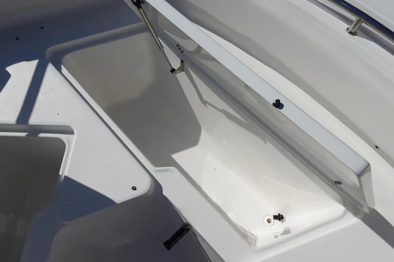 Slide: The Image of Open storage compartment on a 2021 Sea Hunt Ultra 234 boat. - 33