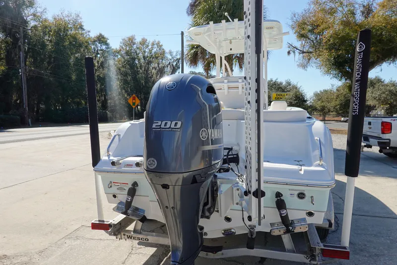 Slide: The Image of 2021 Sea Hunt Ultra 234 boat with Yamaha 200 engine, parked outdoors. - 6