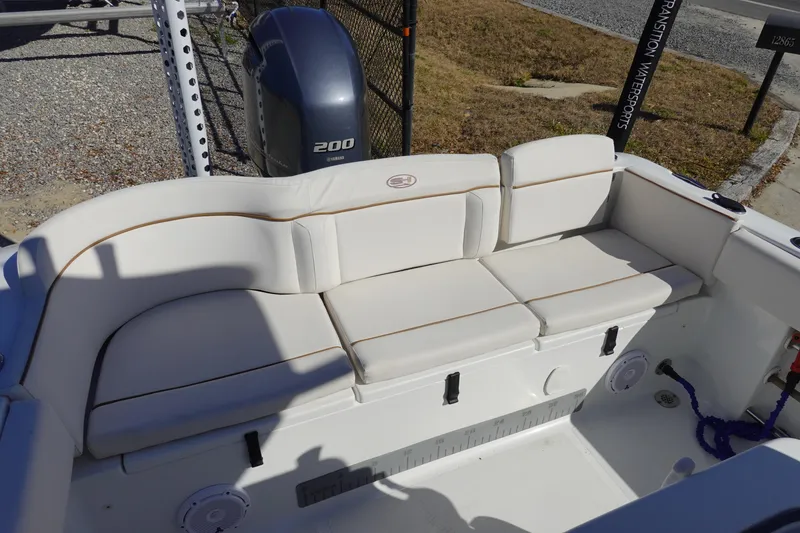 Slide: The Image of 2021 Sea Hunt Ultra 234 boat with white cushioned seating and Yamaha 200 engine. - 8