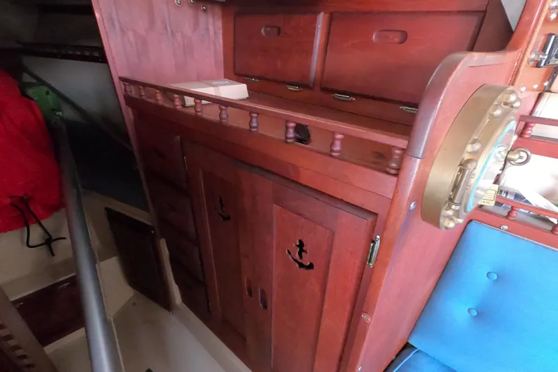 Slide: The Image of Interior of 1980 Catalina 30 sailboat with wooden cabinetry and nautical decor. - 21