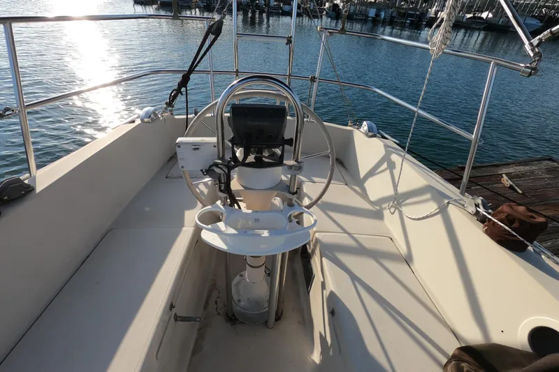 Slide: The Image of Cockpit of a 1980 Catalina 30 sailboat with steering wheel and navigation equipment. - 7